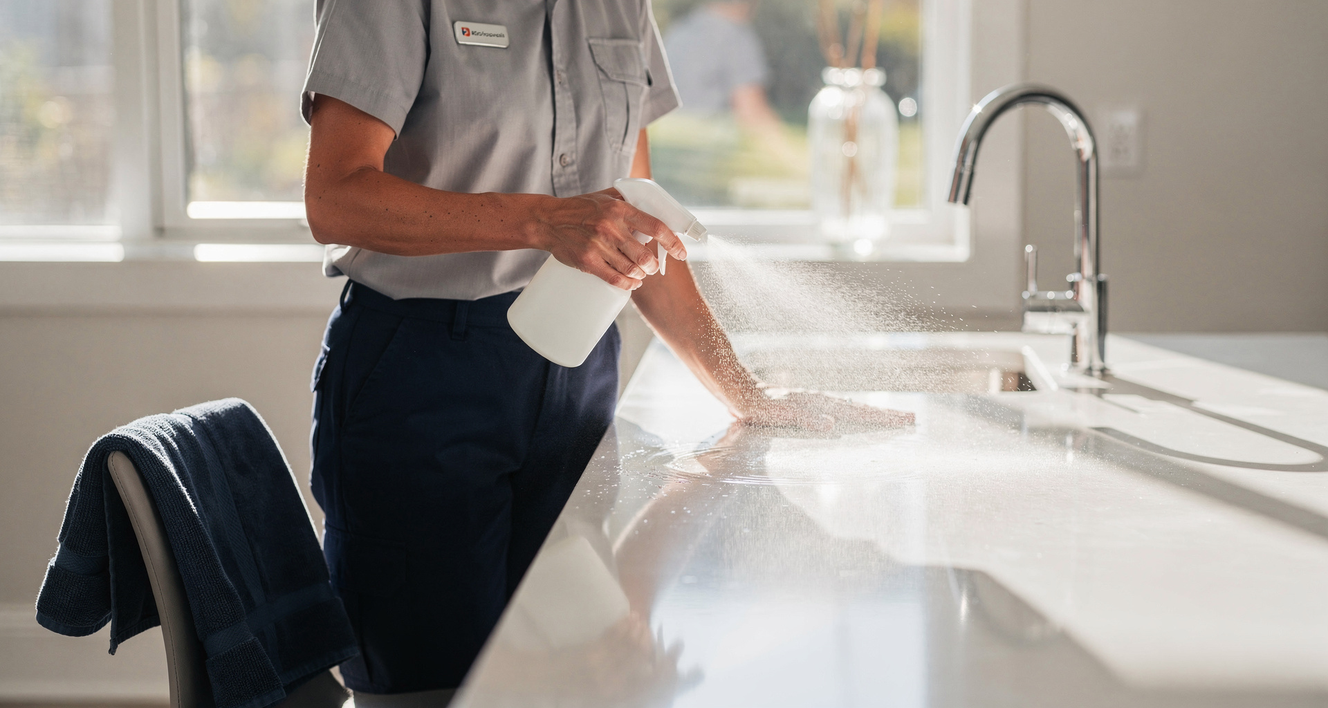 Pristine cleaning specialist sanitizing kitchen surfaces using eco-friendly solutions